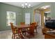 Cozy dining room featuring warm wood furniture, neutral tile floors, and bright natural light at 15287 Coot Rd, Weeki Wachee, FL 34614