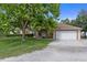 A single Gathering home with beige paint, white trim, and green shrubbery in the front yard at 15287 Coot Rd, Weeki Wachee, FL 34614