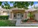 Inviting home entrance featuring a covered porch, manicured landscaping, and decorative front door at 15287 Coot Rd, Weeki Wachee, FL 34614
