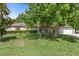 Charming single-story home with a lush front yard and mature trees providing ample shade at 15287 Coot Rd, Weeki Wachee, FL 34614