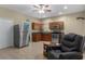 Kitchen with stainless steel appliances, wooden cabinets, and tile floors, offering a functional and stylish cooking space at 15287 Coot Rd, Weeki Wachee, FL 34614
