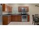 Well-equipped kitchen featuring stainless steel appliances, wooden cabinets, and ample counter space, perfect for cooking at 15287 Coot Rd, Weeki Wachee, FL 34614