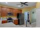 Modern kitchen with dark stainless steel refrigerator, stainless steel oven, and pantry storage at 15287 Coot Rd, Weeki Wachee, FL 34614