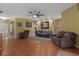 Bright living room with ceiling fan and views to another room creates an inviting atmosphere at 15287 Coot Rd, Weeki Wachee, FL 34614