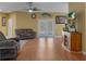 Comfortable living room featuring wood flooring, ceiling fan, and sliding glass doors to the outdoors at 15287 Coot Rd, Weeki Wachee, FL 34614