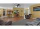 Open-concept living space with views to the kitchen and dining area, featuring wood floors and natural light at 15287 Coot Rd, Weeki Wachee, FL 34614