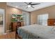 Relaxing primary bedroom with a large TV, natural light, and wood floors at 15287 Coot Rd, Weeki Wachee, FL 34614