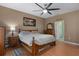 Cozy bedroom with ceiling fan, night stands, and ensuite bathroom at 15287 Coot Rd, Weeki Wachee, FL 34614