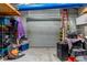 Inside the outbuilding with roll-up door, overhead storage and ladder at 15287 Coot Rd, Weeki Wachee, FL 34614