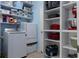 Pantry with laundry machine and shelves stocked with appliances and various household items at 15287 Coot Rd, Weeki Wachee, FL 34614