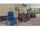 This patio has ceiling fans, a TV, and a comfortable chair that make the space inviting at 15287 Coot Rd, Weeki Wachee, FL 34614