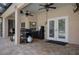 A covered patio offers ceiling fans and a grill, ideal for entertaining near the screened pool at 15287 Coot Rd, Weeki Wachee, FL 34614