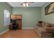 Tranquil home sitting room featuring wood floors, natural light, ceiling fan and comfortable furnishings at 15287 Coot Rd, Weeki Wachee, FL 34614