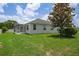 Expansive backyard featuring a screened-in patio and lush green lawn, perfect for outdoor living at 15569 Burbank Dr, Brooksville, FL 34604