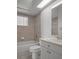 Full bath with tiled shower, tub combination, and a window at 15569 Burbank Dr, Brooksville, FL 34604