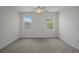 Bedroom with carpeting, a ceiling fan, and window views to the neighborhood at 15569 Burbank Dr, Brooksville, FL 34604