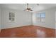 Bright and spacious bedroom with hardwood floors, a ceiling fan, and multiple windows for natural light at 15569 Burbank Dr, Brooksville, FL 34604