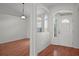 Elegant foyer featuring hardwood floors, arched entryways, and ample natural light streaming through a front window at 15569 Burbank Dr, Brooksville, FL 34604
