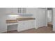 Kitchen features a built in desk and ample cabinet space, as well as tile flooring at 15569 Burbank Dr, Brooksville, FL 34604