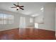 Open-concept living room with hardwood floors, abundant natural light, and seamless connection to the kitchen at 15569 Burbank Dr, Brooksville, FL 34604