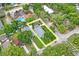 An aerial view outlines the light blue house and the property lines within the neighborhood at 1601 E 98Th Ave, Tampa, FL 33612