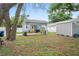 Lush backyard with covered patio area for relaxing and enjoying the outdoors at 1601 E 98Th Ave, Tampa, FL 33612