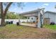 Large backyard with a covered patio, perfect for enjoying outdoor activities at 1601 E 98Th Ave, Tampa, FL 33612