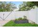 Fenced backyard with raised garden bed, offering a private and serene outdoor space for gardening and relaxation at 1601 E 98Th Ave, Tampa, FL 33612