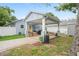 Charming home features a covered patio for outdoor living, with a well-maintained yard at 1601 E 98Th Ave, Tampa, FL 33612