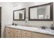 Bathroom featuring double sinks, granite counters, and framed mirrors at 1601 E 98Th Ave, Tampa, FL 33612