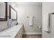 Neutral bathroom with double vanity, sleek hardware, granite counters and wood flooring at 1601 E 98Th Ave, Tampa, FL 33612