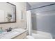 Bathroom featuring a tiled bathtub and a vanity sink with a framed mirror at 1601 E 98Th Ave, Tampa, FL 33612