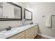 Elegant bathroom featuring double sinks, granite countertops, and framed mirrors at 1601 E 98Th Ave, Tampa, FL 33612