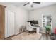 Bedroom with a ceiling fan, a window, and closet. It has a white rug and light wood floors at 1601 E 98Th Ave, Tampa, FL 33612