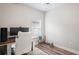 Home office with a fan, window, white shag rug, and wood floors at 1601 E 98Th Ave, Tampa, FL 33612