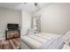 Bedroom with ceiling fan, wood-look flooring and chair by the window at 1601 E 98Th Ave, Tampa, FL 33612