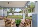 Relaxing covered patio with comfortable seating, overlooking a spacious backyard and manicured lawn at 1601 E 98Th Ave, Tampa, FL 33612