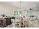 Inviting dining room with wood table, stylish chandelier, and beverage center at 1601 E 98Th Ave, Tampa, FL 33612