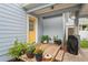 Inviting front porch with a bright yellow door, potted plants, and a cozy atmosphere, great curb appeal at 1601 E 98Th Ave, Tampa, FL 33612
