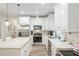 Bright kitchen with white cabinets, stainless steel appliances, and granite countertops at 1601 E 98Th Ave, Tampa, FL 33612