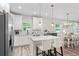 Bright kitchen featuring a center island with breakfast bar and modern pendant lights at 1601 E 98Th Ave, Tampa, FL 33612
