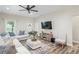 Bright living room featuring a modern ceiling fan, TV, and lots of comfortable seating at 1601 E 98Th Ave, Tampa, FL 33612