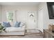 Bright living room showcasing a comfortable couch, modern flooring, and a stylish rug at 1601 E 98Th Ave, Tampa, FL 33612
