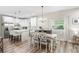 Open-concept kitchen and dining area with a modern island and stylish decor at 1601 E 98Th Ave, Tampa, FL 33612