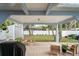 Spacious covered patio with outdoor seating offers peaceful backyard views at 1601 E 98Th Ave, Tampa, FL 33612