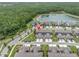 Aerial view of houses near a big lake and a forest at 17316 Cruiser Bnd, Land O Lakes, FL 34638