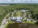 Aerial view of the community clubhouse and pool area, surrounded by lush landscaping and mature trees at 17316 Cruiser Bnd, Land O Lakes, FL 34638
