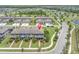 Aerial view of townhomes in a well-maintained community with ponds and lush landscaping at 17316 Cruiser Bnd, Land O Lakes, FL 34638