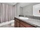 Functional bathroom with a shower-tub combo, single sink vanity and granite countertop at 17316 Cruiser Bnd, Land O Lakes, FL 34638