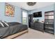 Bedroom with blue walls, sleek black furniture, and modern decor features a TV and aquarium at 17316 Cruiser Bnd, Land O Lakes, FL 34638